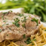 Crock-Pot ranch pork chops on a plate garnish with parsley