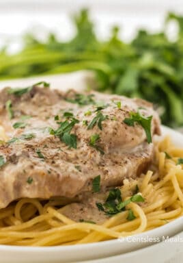 Crock-Pot ranch pork chops on a plate garnish with parsley