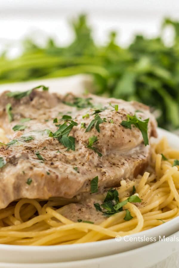 Crock-Pot ranch pork chops on a plate garnish with parsley