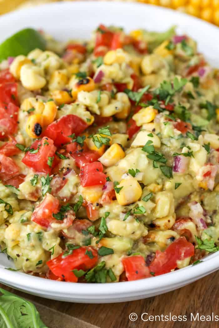 A white bowl filled with grilled corn guacamole