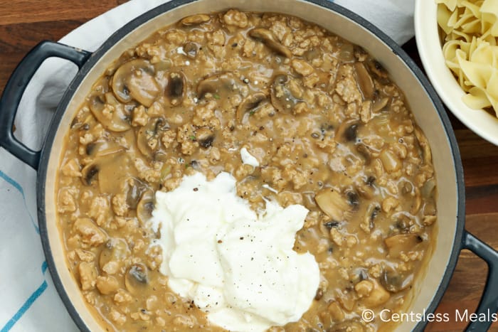 Creamy beef mushroom stroganoff sauce mixed with sour cream in a pot