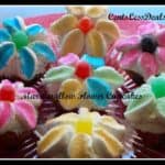 Marshmallow flower cupcakes on a plate with a title