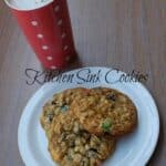 kitchen sink cookies on a white plate with hot chocolate