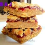 peanut butter and jelly bars on a white plate with a title