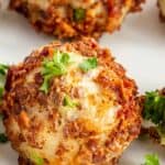 Mashed potato ball on a plate with parsley on top