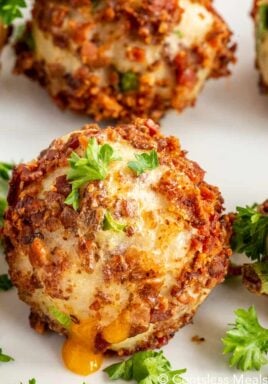 Mashed potato ball on a plate with parsley on top