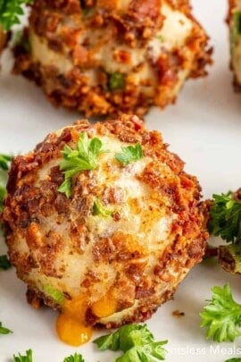 Mashed potato ball on a plate with parsley on top