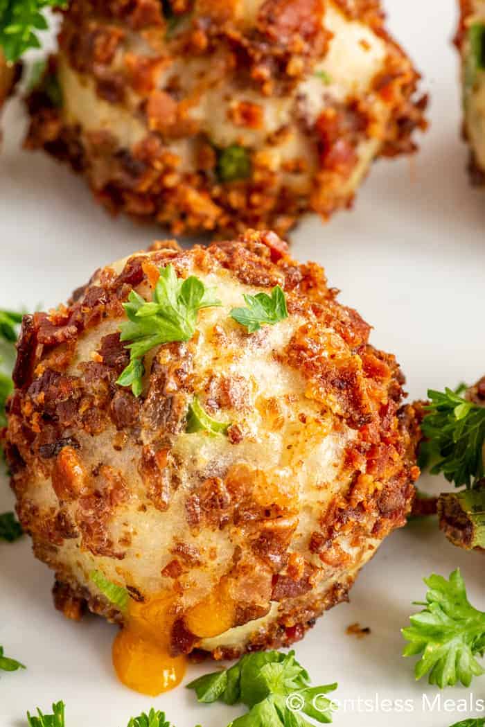 Close up of a mashed potato ball garnished with parsley.