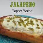 jalepeno popper bread on a blue plate topped with jalapenos and a title
