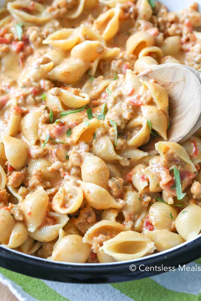 Taco pasta in a bowl with a wooden spoon