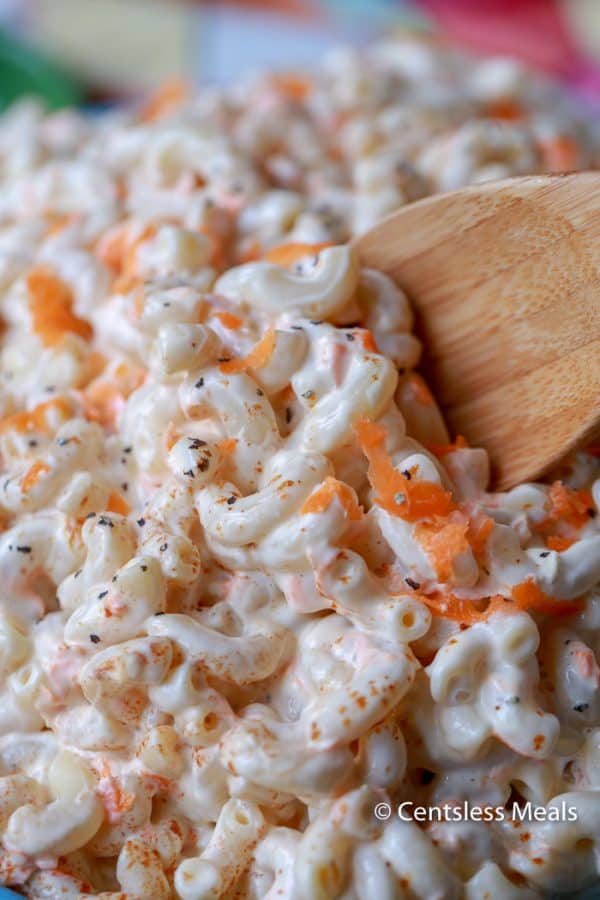 Macaroni salad with a wooden spoon