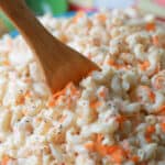 Classic macaroni salad in a bowl with a wooden spoon