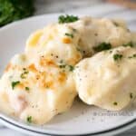 Cheesy chicken stuffed shells on a plate with parsley