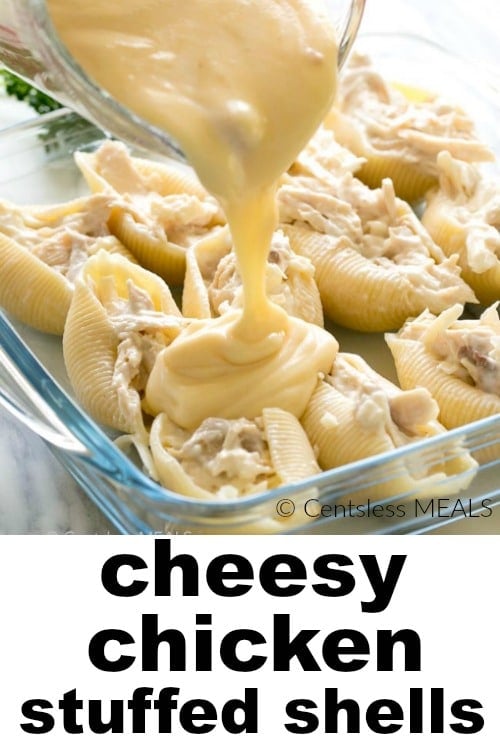 Cheesy chicken stuffed shells in a casserole dish with cheese being poured on and a title