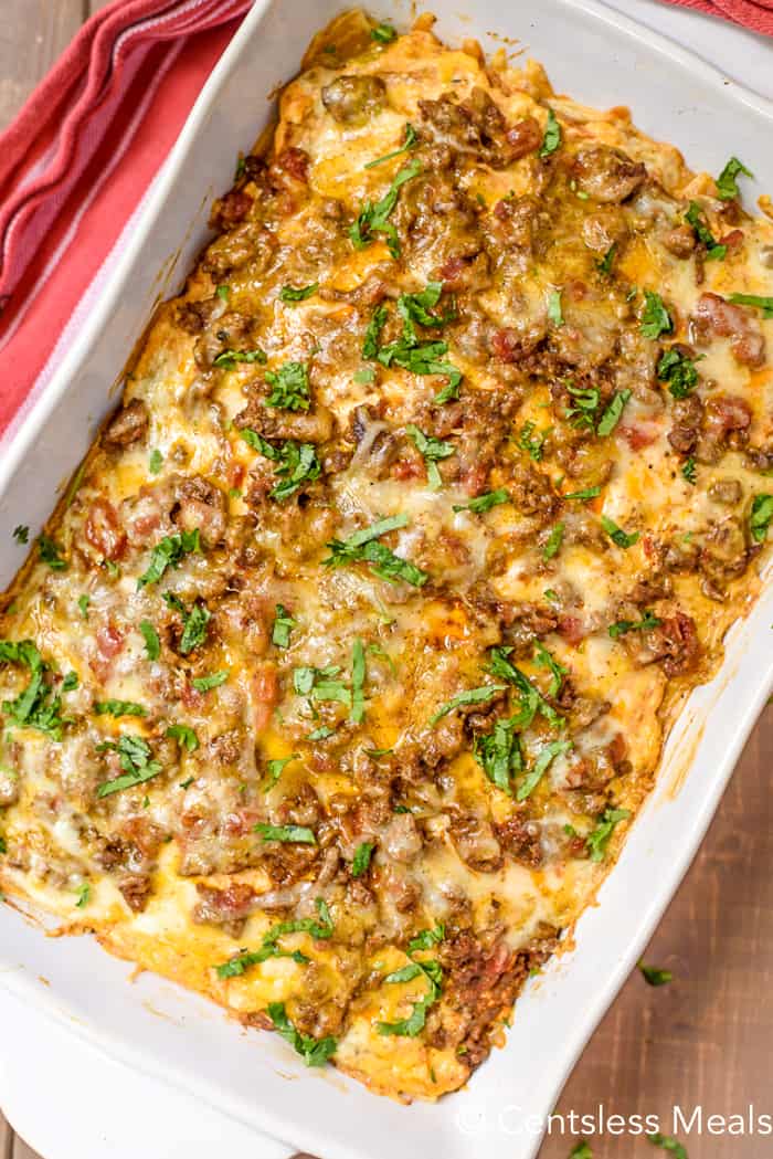 Taco bake in a casserole dish garnished with cilantro
