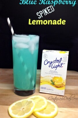 Blue raspberry spiked lemonade in a glass with Crystal Light and slices of lemonade