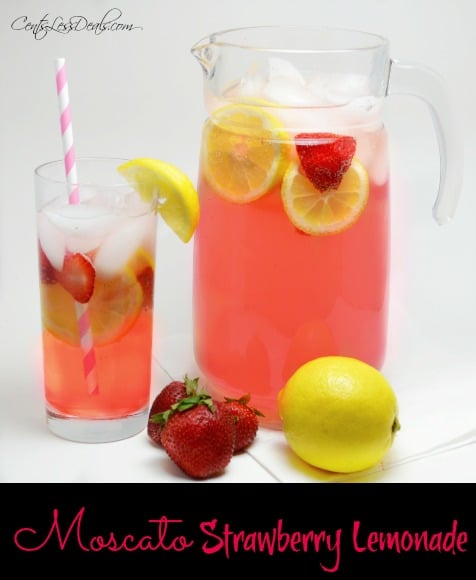 Moscato strawberry lemonade in a glass and in a glass pitcher with strawberries and lemon on the side