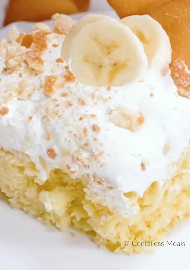 Banana Pudding poke cake with whipped cream and bananas