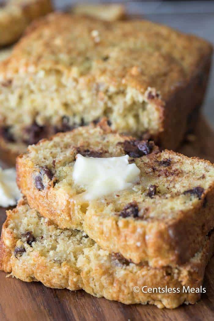 Cake mix banana bread on a wooden board with melted butter on top