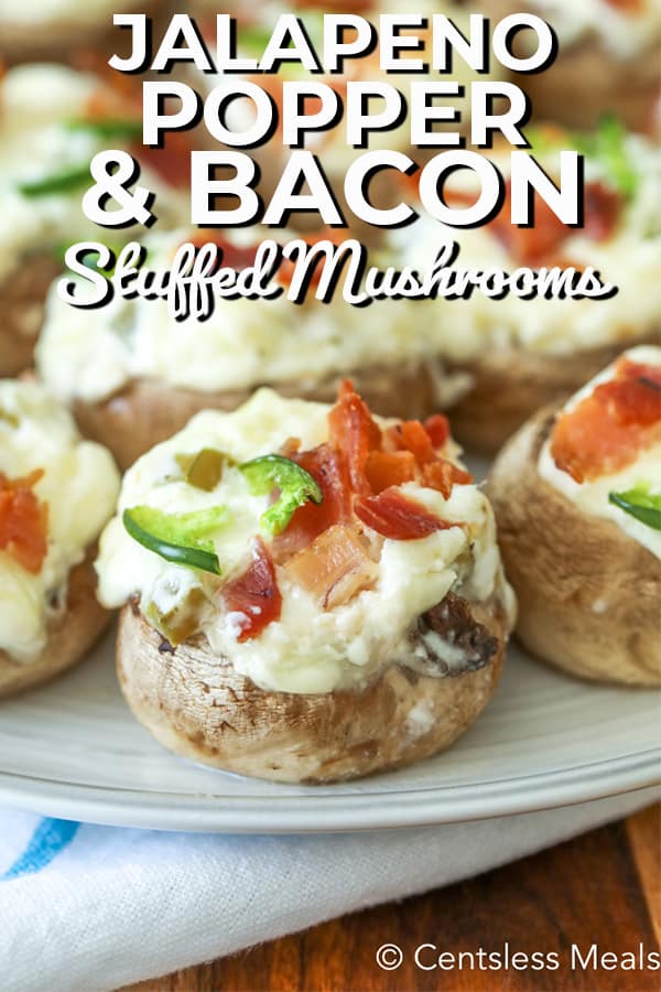 Jalapeno popper and bacon stuffed mushrooms on a plate with writing