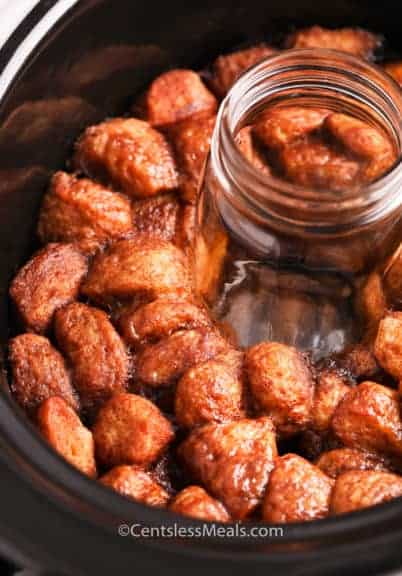 Monkey bread in a crock pot with a mason jar in the middle