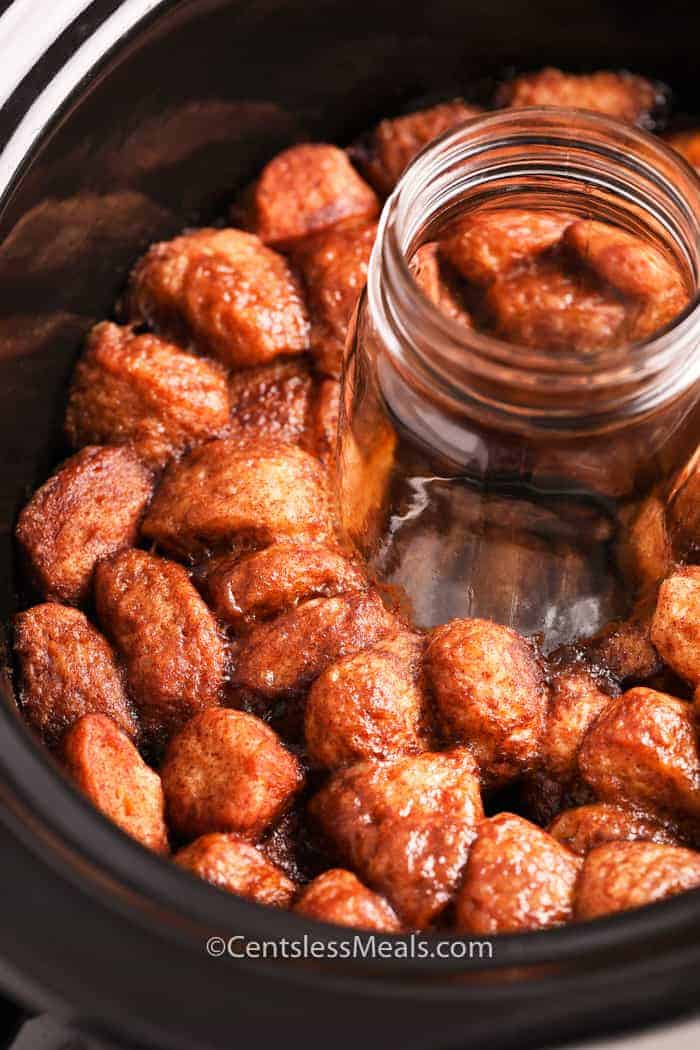 Monkey bread in a crock pot with a mason jar in the middle