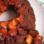 Monkey bread on a plate with pieces broken off