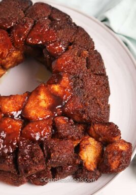 Monkey bread on a plate with pieces broken off