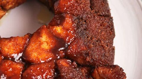 Monkey bread on a plate with pieces broken off