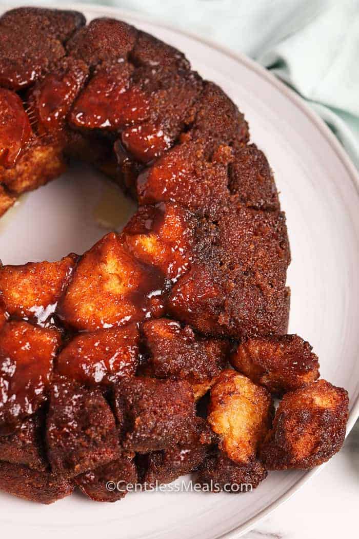 Monkey bread on a plate with pieces broken off