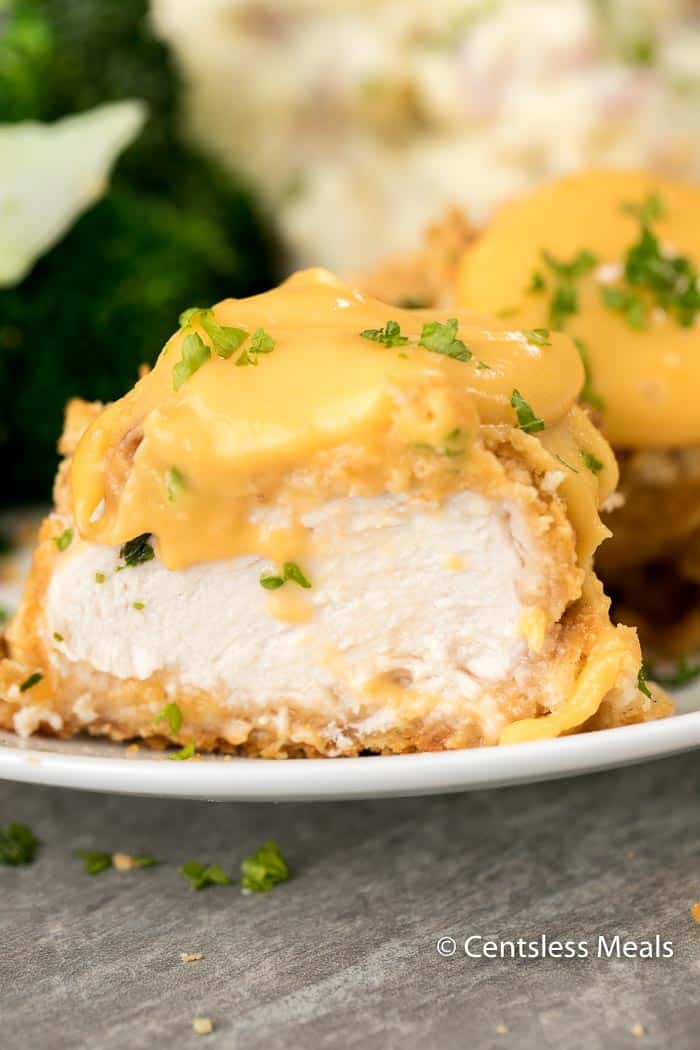 Ritz cracker chicken with cheese and parsley on a white plate