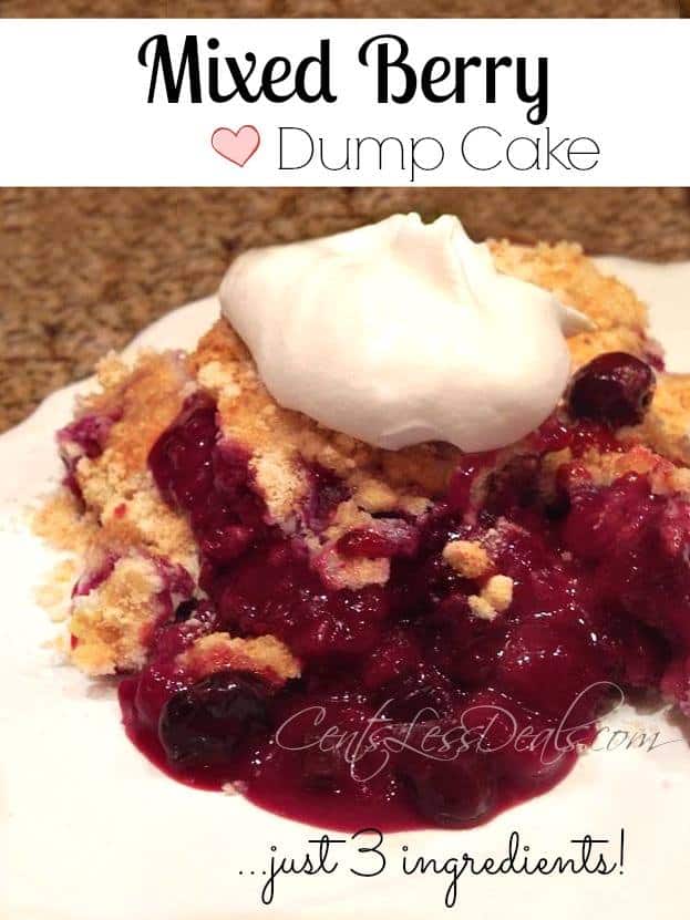 Mixed berry dump cake on a plate with whipped cream and writing