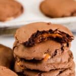 Stack of caramel chocolate cake mix cookies with a bite taken out of 1