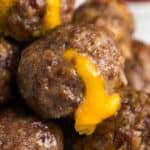 Bacon cheeseburger meatballs on a plate with cheese oozing out