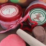 Peppermint playdough and gingerbread playdough in jars and on the counter with a rolling pin and a title