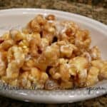 Marshmallow caramel popcorn in a bowl with writing