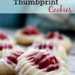 Cherry thumbprint cookies on a wooden board with a title