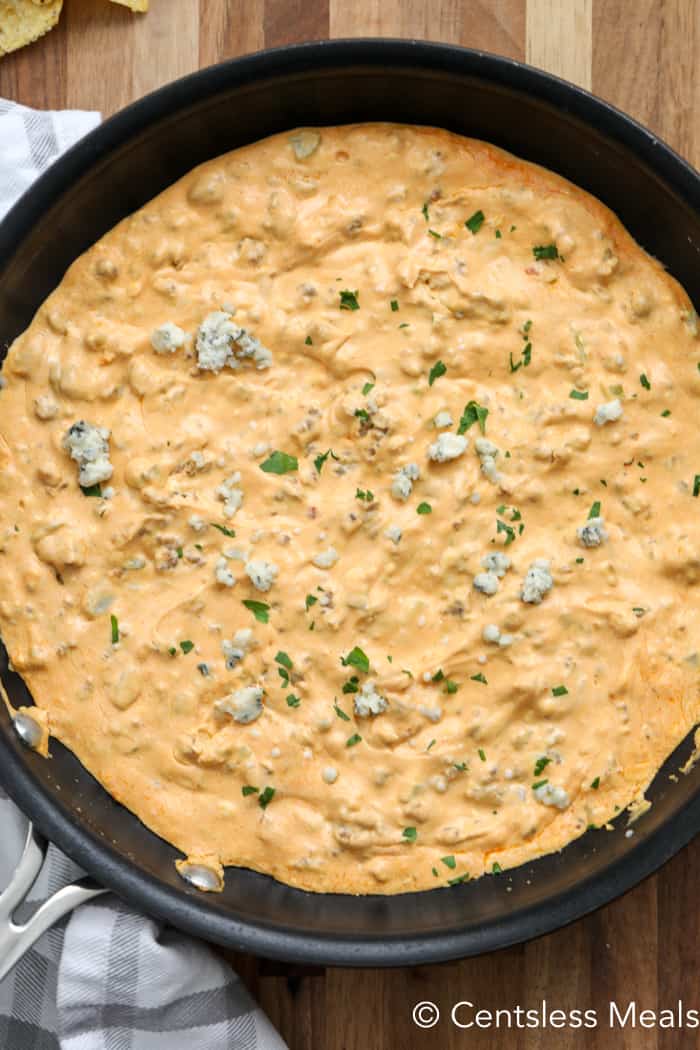 Buffalo sausage dip in a pan with parsley