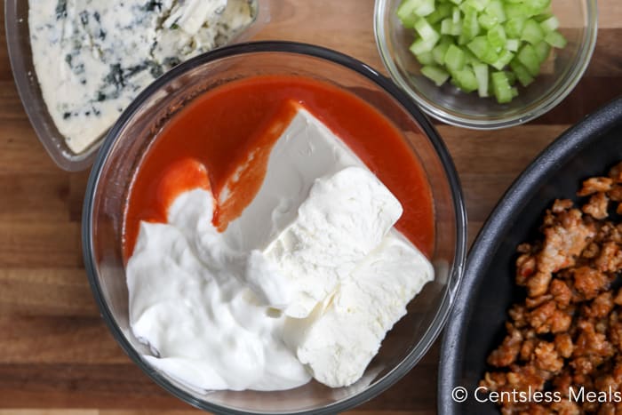 Ingredients for Buffalo sausage dip in bowls