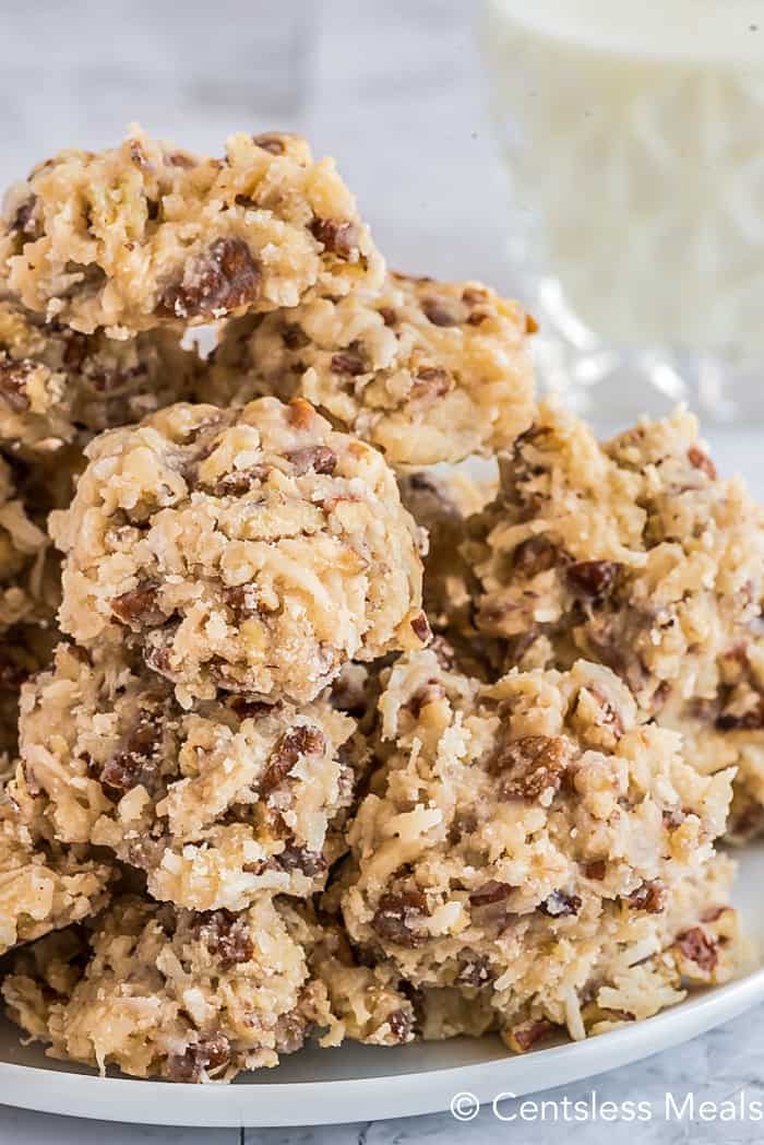 close up of a pile of Coconut Pecan Cookies on a white plate