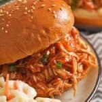 Crock-Pot BBQ beer chicken sandwiches on a plate with macaroni salad