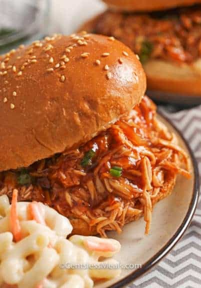 Crock-Pot BBQ beer chicken sandwiches on a plate with macaroni salad