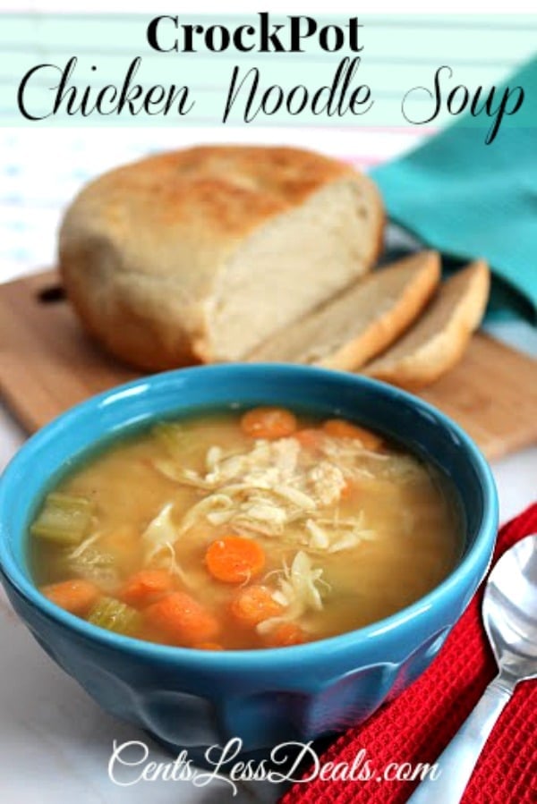 Crock-Pot chicken noodle soup in a blue bowl with a spoon and a loaf of bread on a wooden board in the background with a title