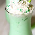 Shamrock shake with whipped cream sprinkles and a cherry on top