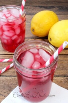 Copycat Starbucks passion tea lemonade in mason jars with straws and ice and lemons on the side