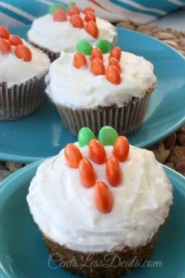 Carrot cake cupcakes on plates with M&M's on top