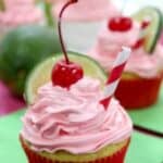 Cherry limeade cupcakes with icing, lime and cherries on top