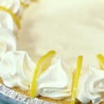 Creamy lemon pie with whipped cream and lemon slices