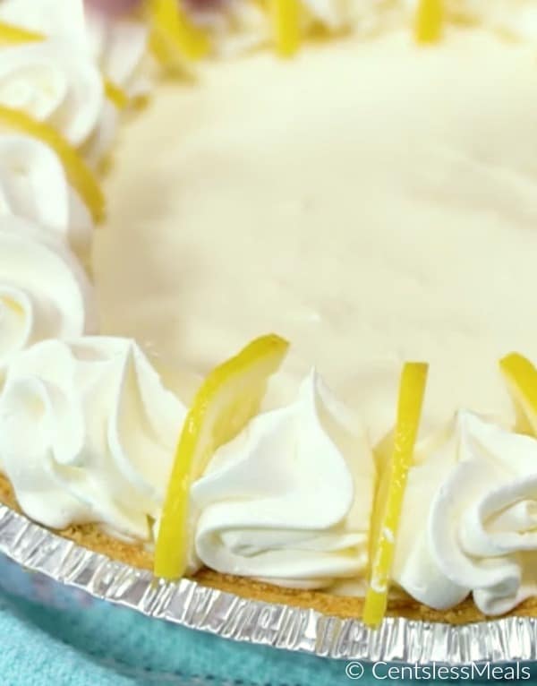 Creamy lemon pie with whipped cream and lemon slices