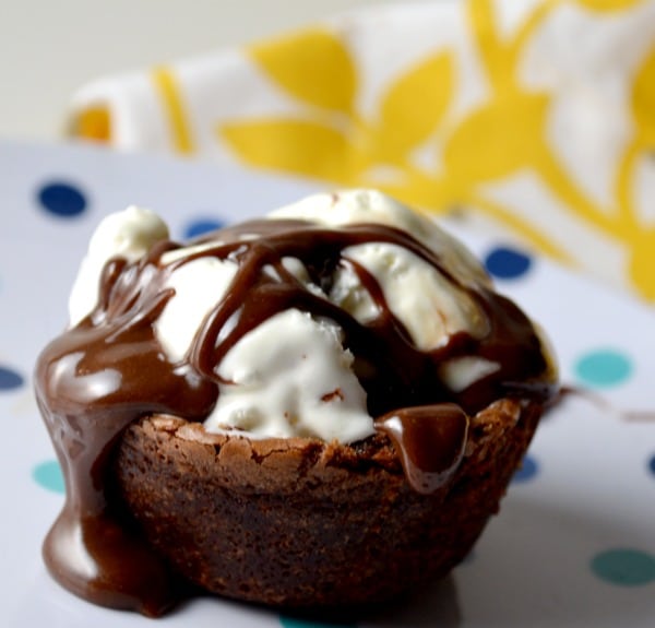 Brownie on a plate with ice cream and chocolate sauce